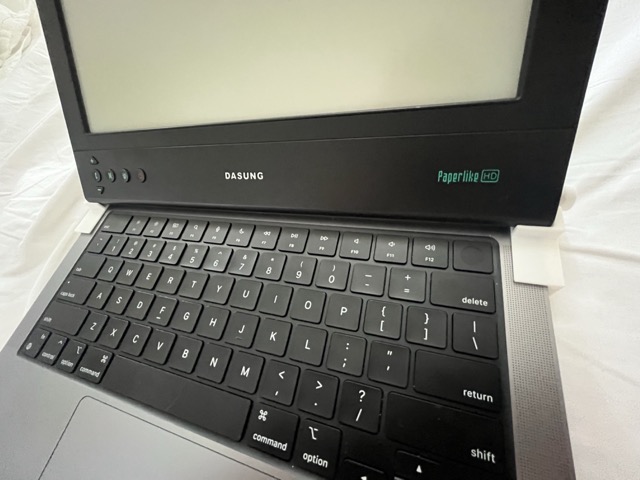 laptop with monitor rested on it and hinges
