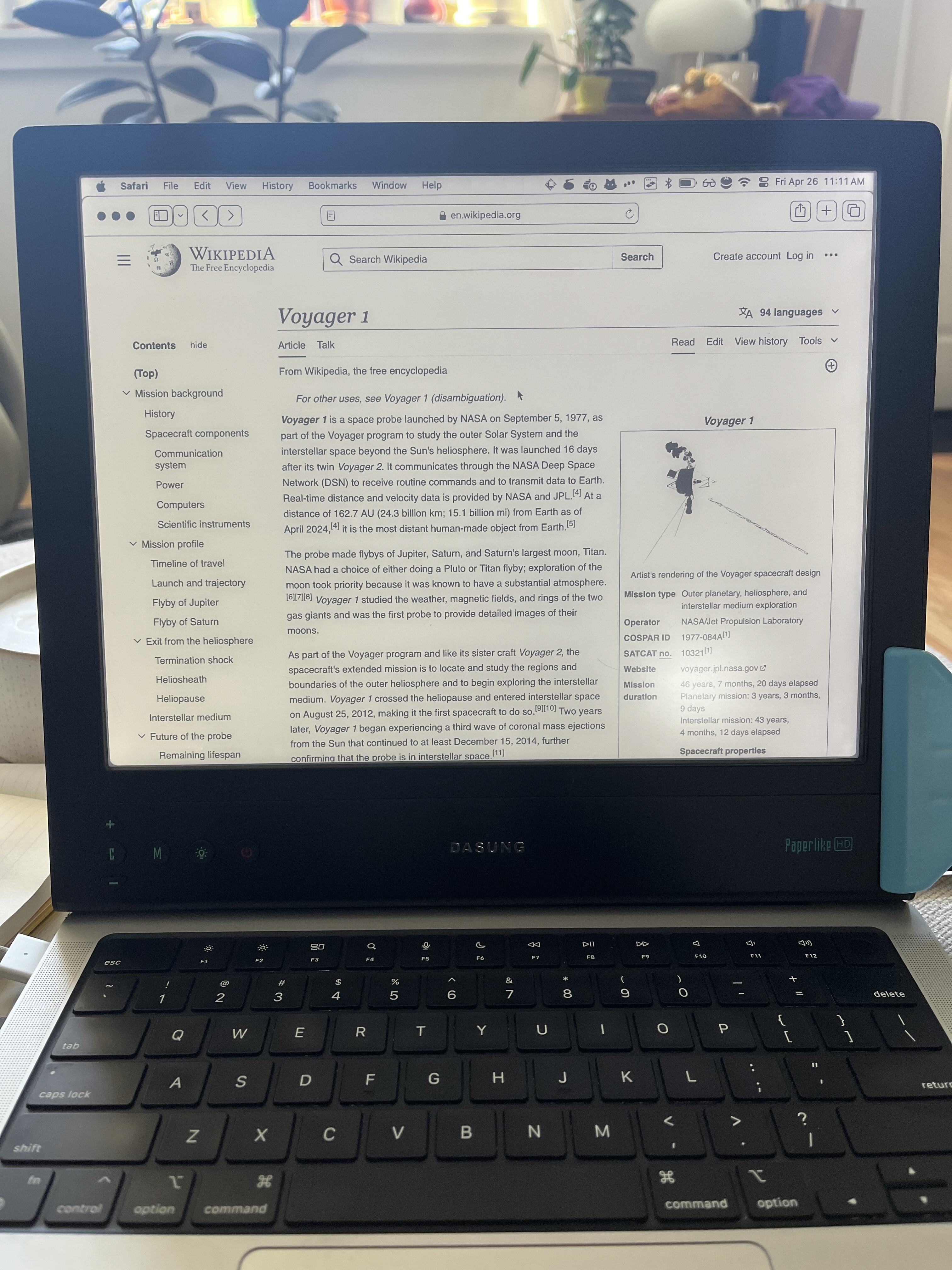 DASUNG monitor rested on top of laptop with bag clip